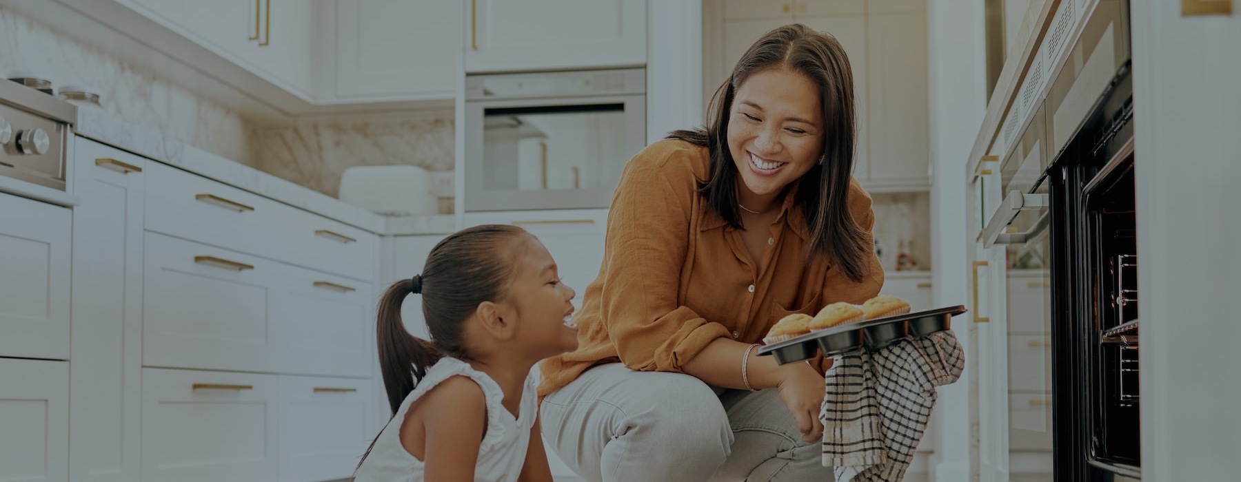 a woman and a child in a kitchen